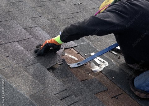 roofer removing shingles